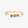 gold Minimalist Dainty Birthstone Ring with three birthstones on on a white background