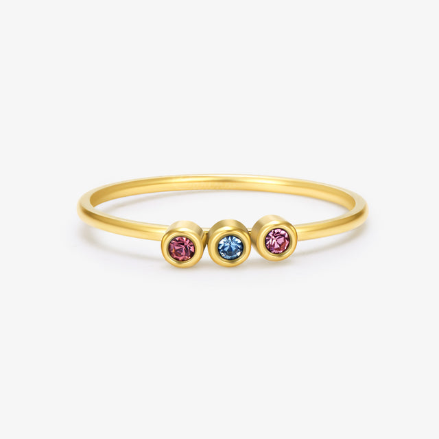 gold Minimalist Dainty Birthstone Ring with three birthstones on on a white background
