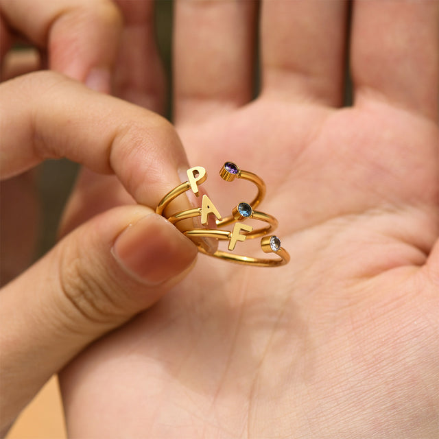 model holding 3 Initial Letter Birthstone Rings