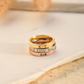 gold, silver, and rose gold Custom Engraved Rings on flat white stone