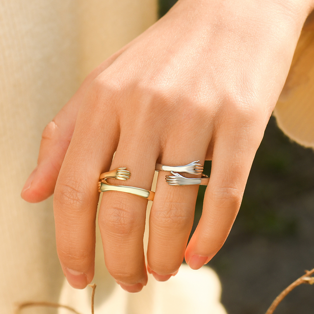 model wearing gold and silver Custom Hug Rings