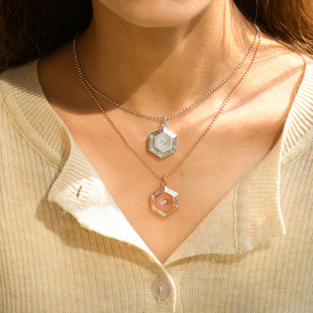 model wearing silver and rose gold Pentagon Locket Necklaces