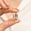 model holding 3 Minimalist Dainty Birthstone Ring with three birthstones per ring