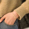 model wearing a gold-colored Minimalist Chain Bracelet