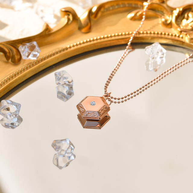 rose gold Pentagon Locket Necklace on mirror with transparent crystals