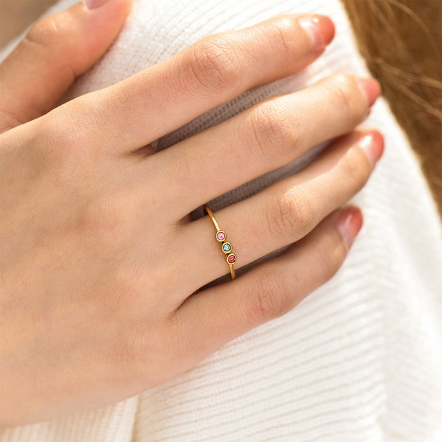 model wearing gold Minimalist Dainty Birthstone Ring with three birthstones