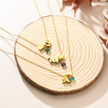 3 Personalized Birthstone and Initial Necklace on a piece of wood
