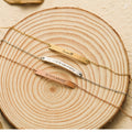 gold, silver, and rose gold variants of Minimalist Chain Bracelet on a piece of wood