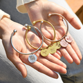 silver, gold, and rose gold Personalized Pet Portrait Name Cuff Bracelets on model's palms