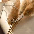 silver Kids Fairy Name Necklace on leaves