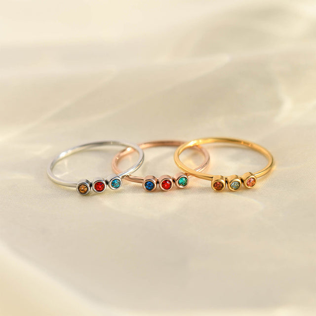 silver, gold, and rose gold Minimalist Dainty Birthstone Rings stack together on a plain canvas