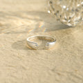 creative shot of Custom Paw Pet Ring with the engraved personalized name inside