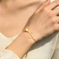 model wearing the gold Beauty and the Beast Rose Initial Bracelet