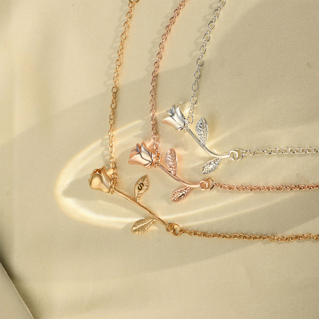 three variants of Beauty and the Beast Rose Initial Bracelet - rose gold, silver, gold on a blank page