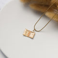 an opened Cross Locket Necklace on top of white canvas