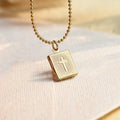 Cross Locket Necklace on off-white canvas