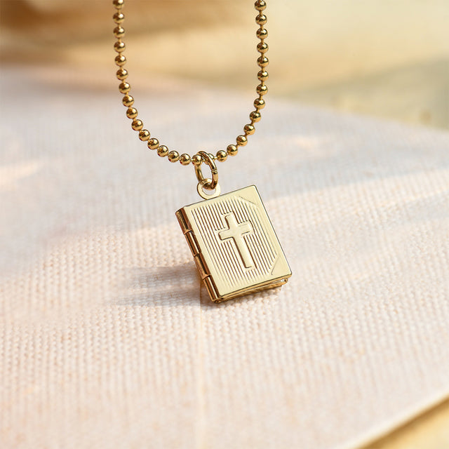 Cross Locket Necklace on off-white canvas