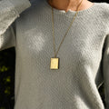 model wearing a gold Cross Photo Box Locket Necklace