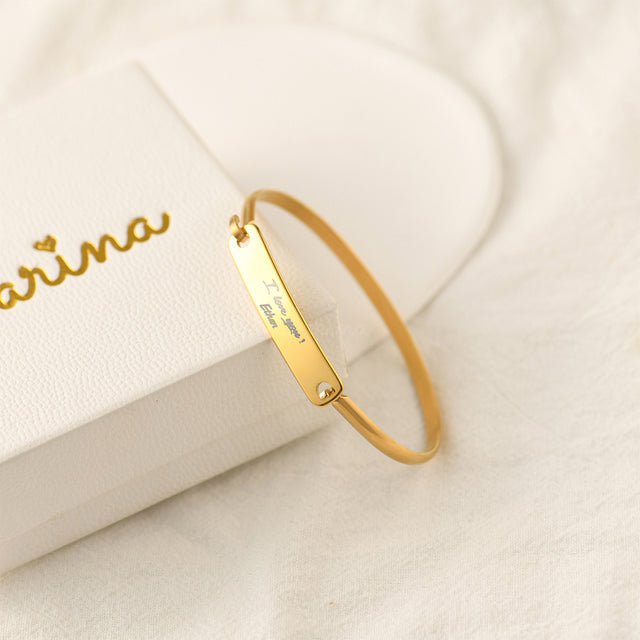 gold Custom Handwriting Bar Bracelet beside Carina white box packaging on a white canvas