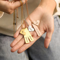 model showing the three Custom Bar and Heart Necklace in gold, silver and rose gold variants