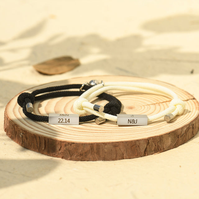 white and black Custom Couple Magnetic Bracelet on a piece of wood