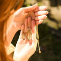 model holding an opened Double Heart Locket Necklace