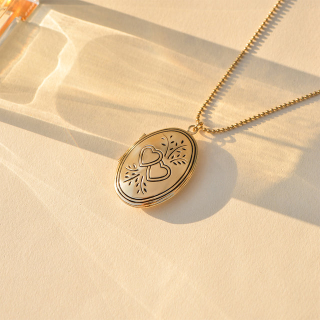 Double Heart Locket Necklace on plain canvas