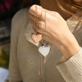 model holding rose gold and silver Engraved Heart Locket Necklaces