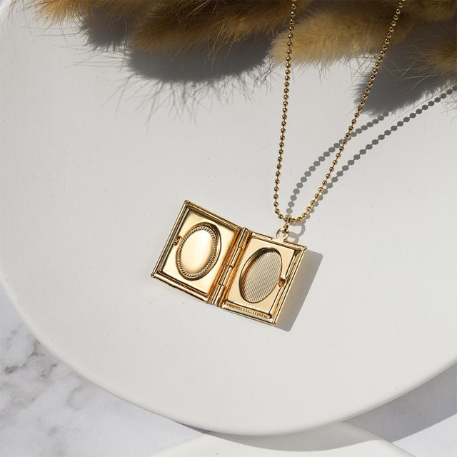 an opened Personalized Book Locket Necklace on white disc