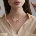 model wearing the gold Round Ball Locket Necklace