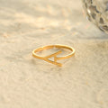gold Stackable Sideway Initial Ring on sand
