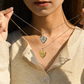 model holding silver and gold Stone Heart Locket Necklaces
