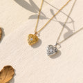 gold and silver Stone Heart Locket Necklace on canvas with leaves