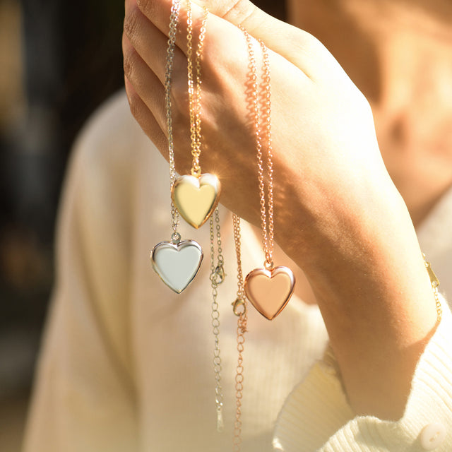 model holding silver, gold, rose gold Minimalist Heart Locket Necklaces