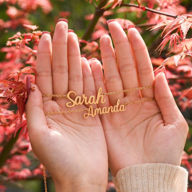 Gold Personalized Fairy Name Necklaces with autumn leaves background.