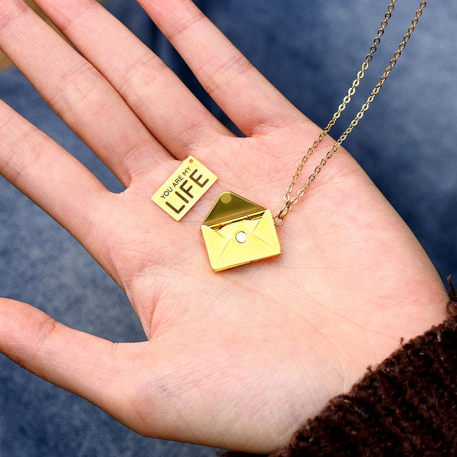 Model holding Personalized Love Letter Necklace