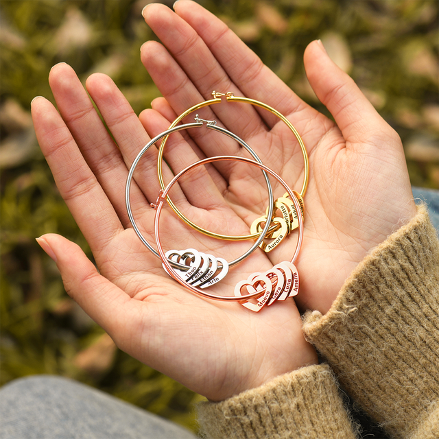 Gold, silver, and rose gold variants of Personalized Hearts Charm Bracelet on model hand