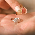 gold and silver Family Monthly Florals Rings on model's palm