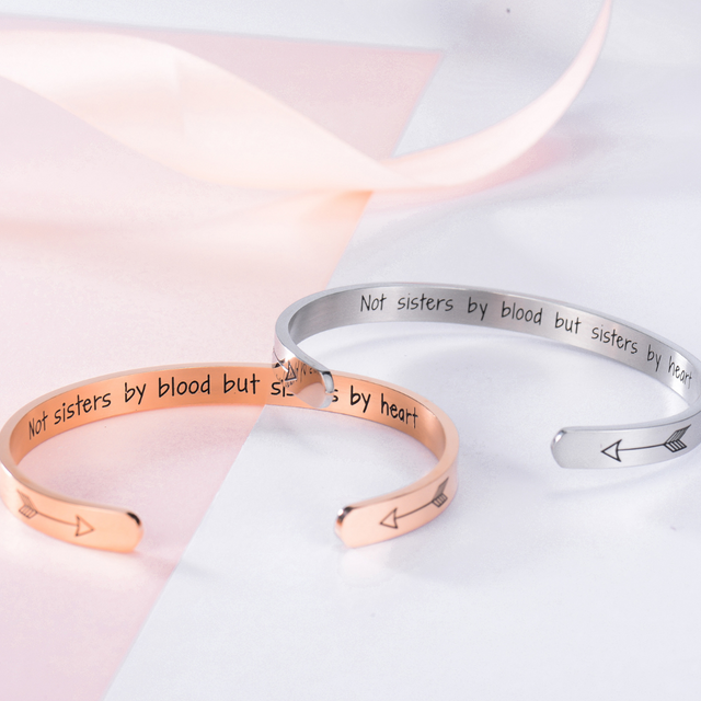 lifestyle shot of rose gold and silver colored Not Sisters By Blood, But Sisters By Heart Bracelets