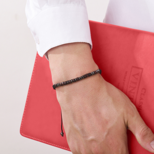 male model holding a red book wearing To My Grandson, I Love You Morse Code Bracelet