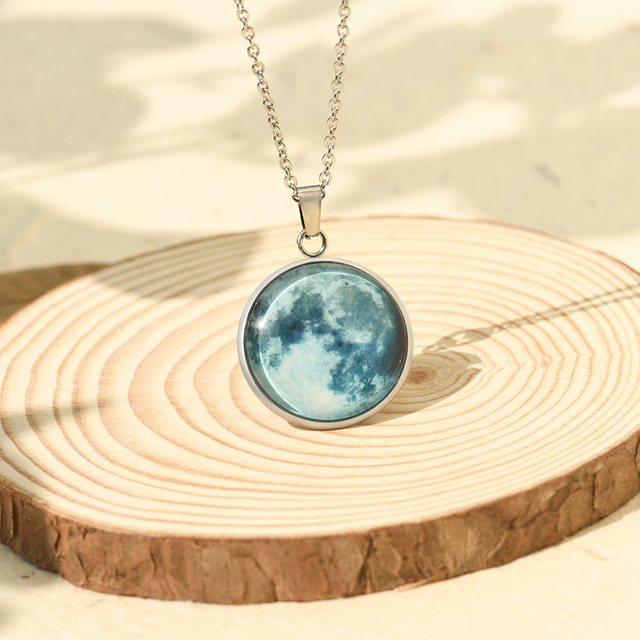 Custom Moon Phase Necklace on a piece of wood