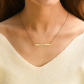 model wearing a gold Custom Mini Bar Necklace