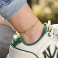 model wearing a gold Personalized Script Name Anklet