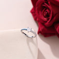 Half Enamel Ring on top of a white canvas and a red rose with it