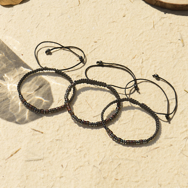 Inspirational Morse Code Bracelets stack together on sand