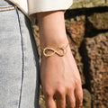 model wearing gold Infinity Name Bracelet