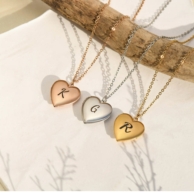 rose gold, silver, and gold Initial Heart Locket Necklaces on a tree branch