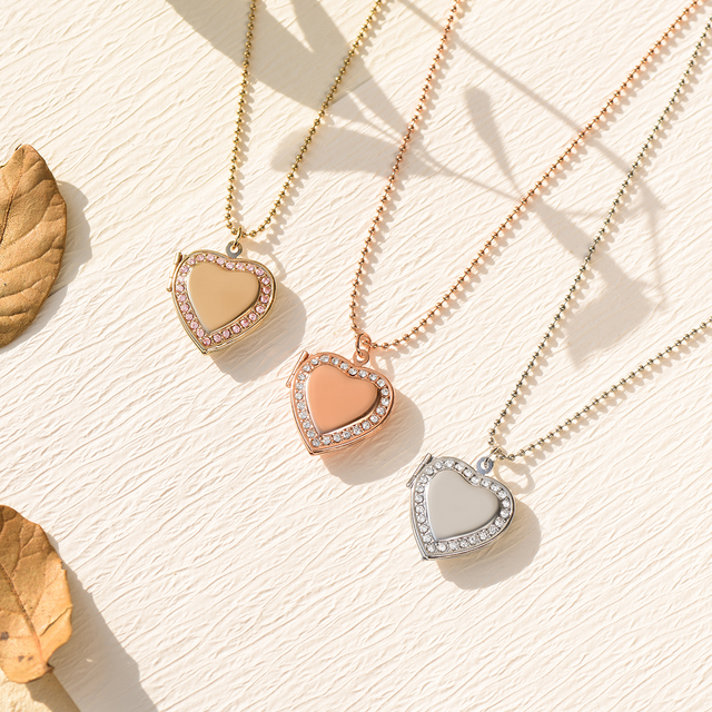 gold, rose gold, and silver Dainty Heart Locket Necklaces on canvas