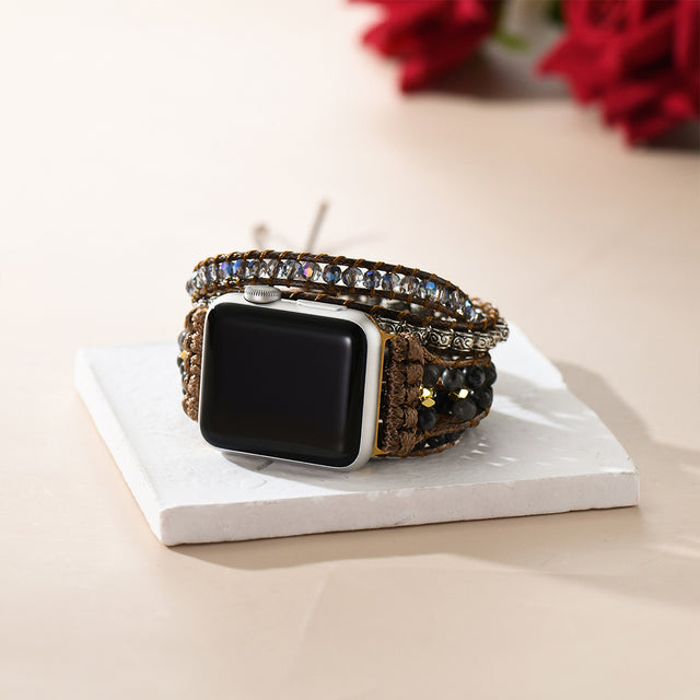 creative shot of Apple watch band on a white square disc with a red flower at the back