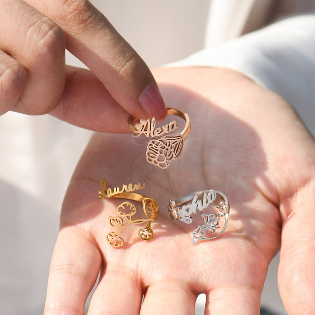 rose gold, gold, and silver variant Custom Birth Flower and Name Rings on model's palm